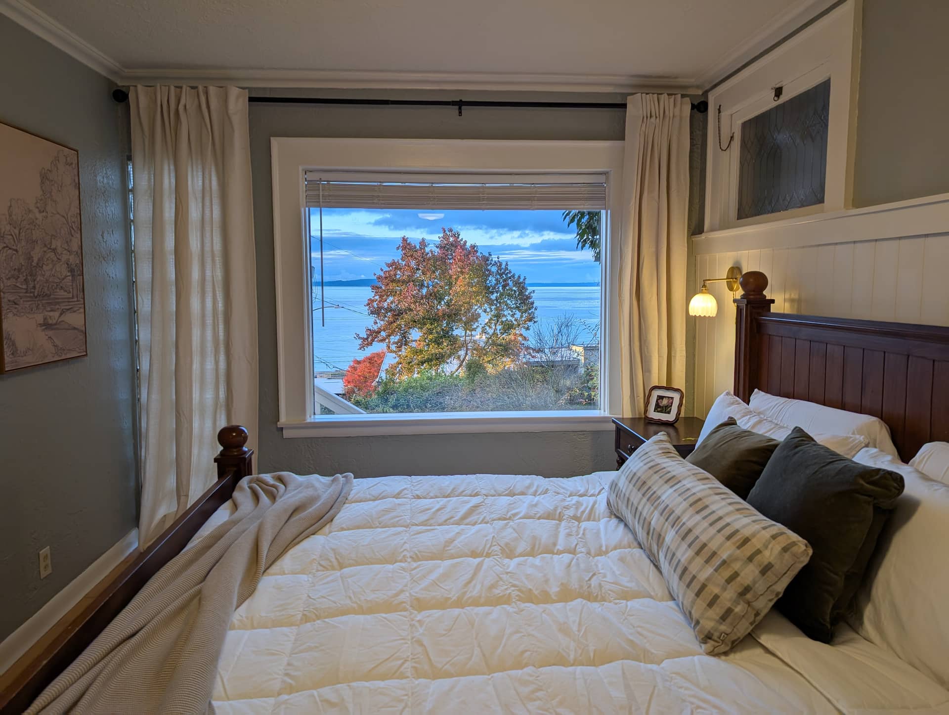 King bed with Puget Sound views at The Alki Retreat